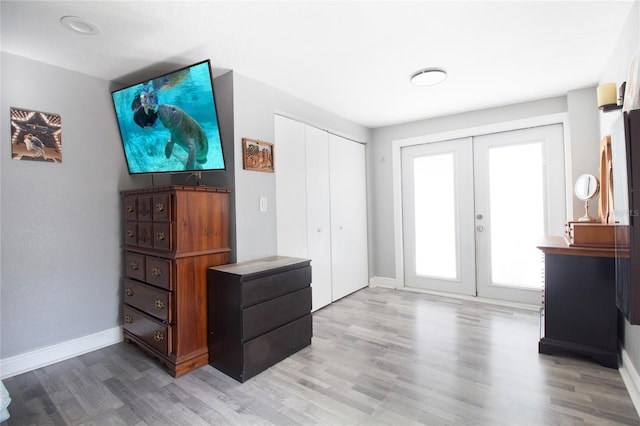 interior space with french doors and hardwood / wood-style flooring