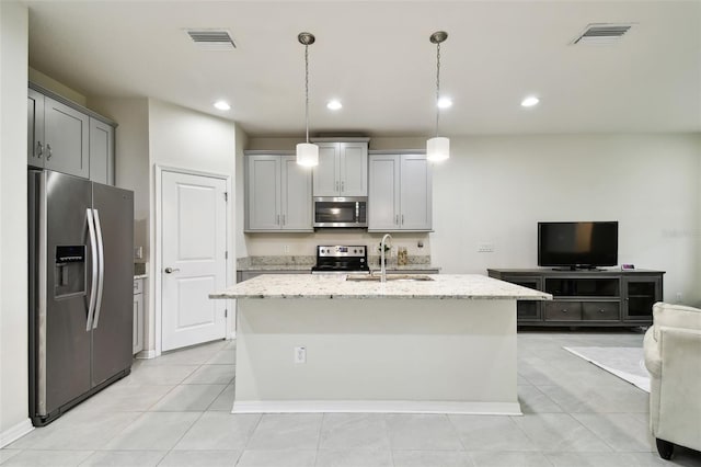 kitchen featuring sink, decorative light fixtures, light stone counters, gray cabinets, and stainless steel appliances