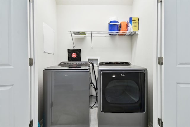 clothes washing area featuring washer and clothes dryer