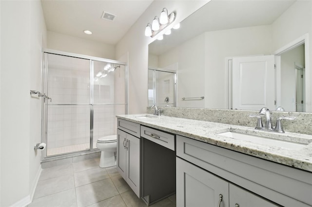 bathroom featuring an enclosed shower, vanity, toilet, and tile patterned flooring