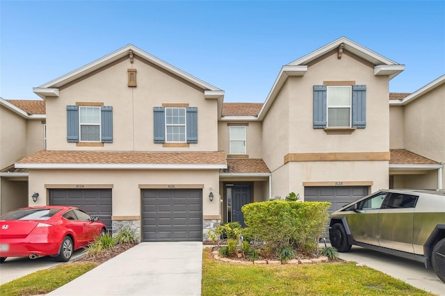 townhome / multi-family property featuring a garage