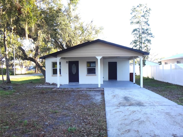 view of front of home featuring covered porch and a carport