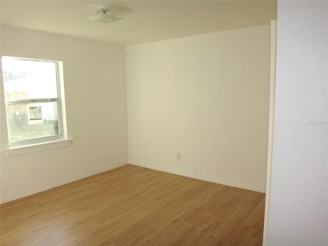 empty room with light hardwood / wood-style flooring