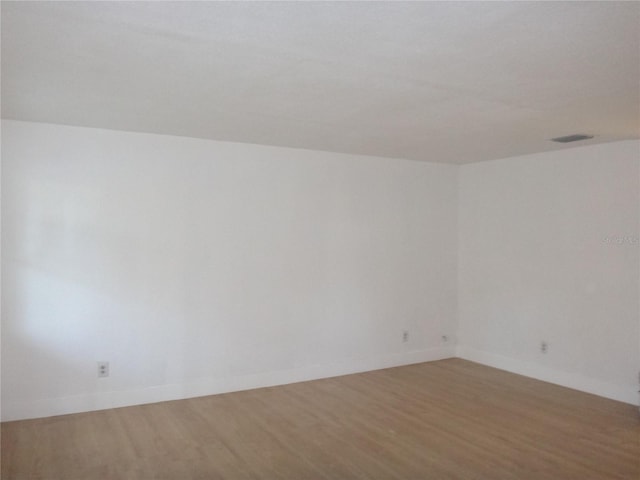 spare room featuring hardwood / wood-style floors