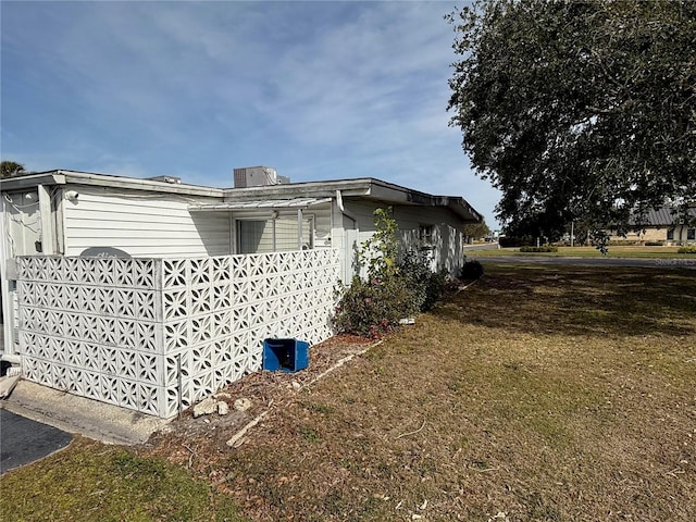 view of side of home featuring a yard