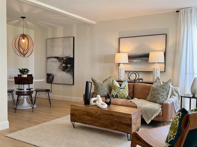 sitting room with hardwood / wood-style floors and a textured ceiling