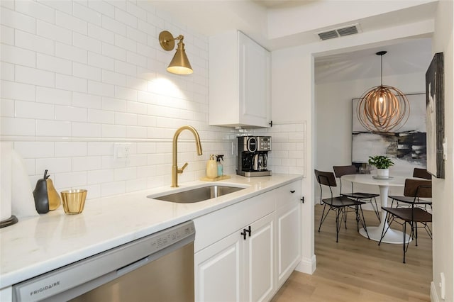 kitchen featuring dishwasher, decorative light fixtures, white cabinets, and sink