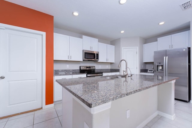 kitchen with sink, white cabinets, an island with sink, and appliances with stainless steel finishes