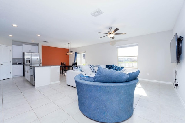 living room featuring light tile patterned flooring and ceiling fan