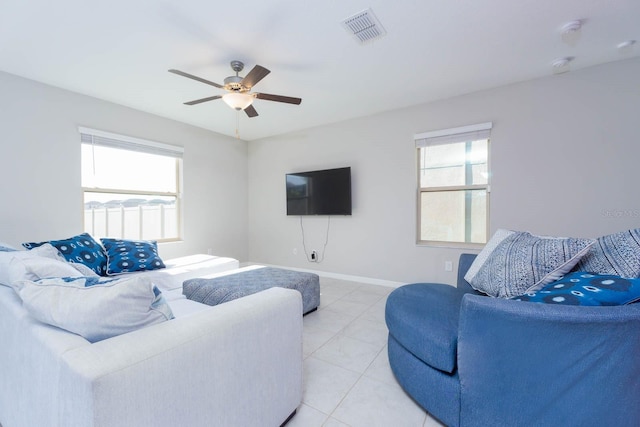 tiled living room with ceiling fan