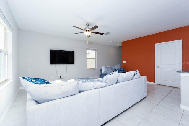 tiled living room featuring ceiling fan and a wealth of natural light