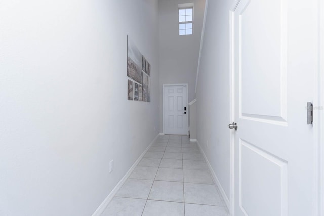 hall featuring light tile patterned floors