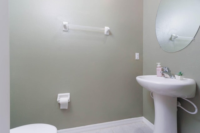 bathroom with tile patterned floors and toilet