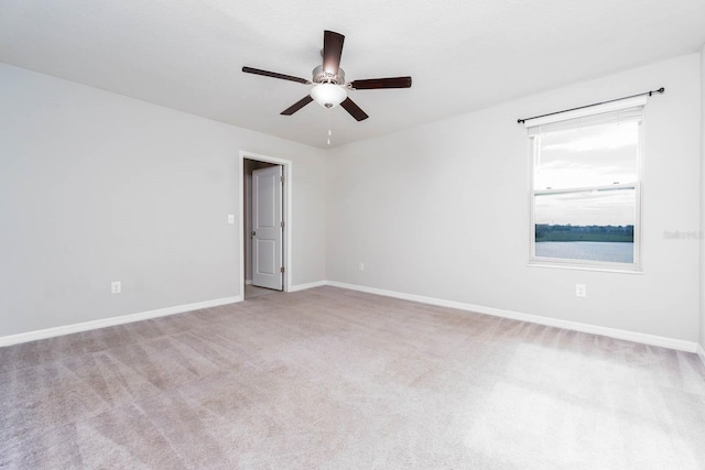 spare room with light carpet and ceiling fan