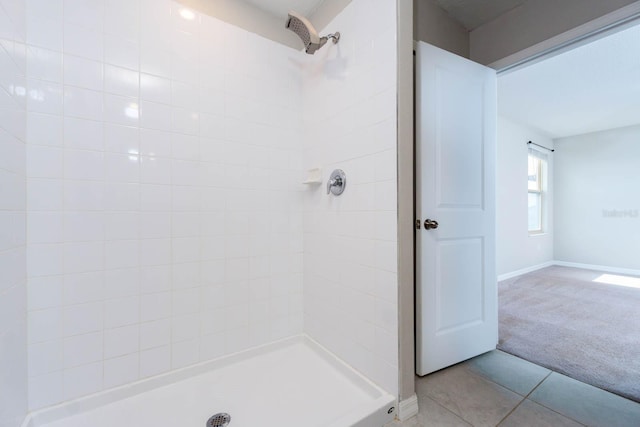 bathroom with tile patterned flooring and a shower