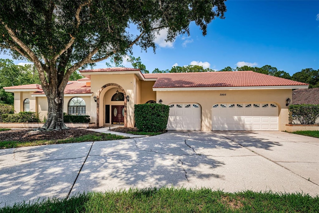 mediterranean / spanish-style house featuring a garage