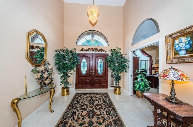 foyer entrance with a towering ceiling and an inviting chandelier