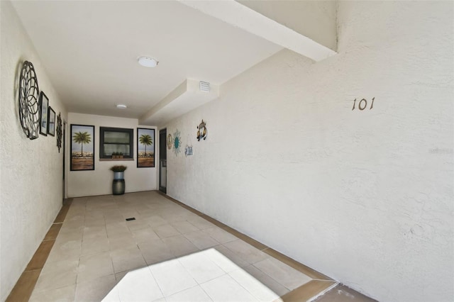 hallway with light tile patterned floors