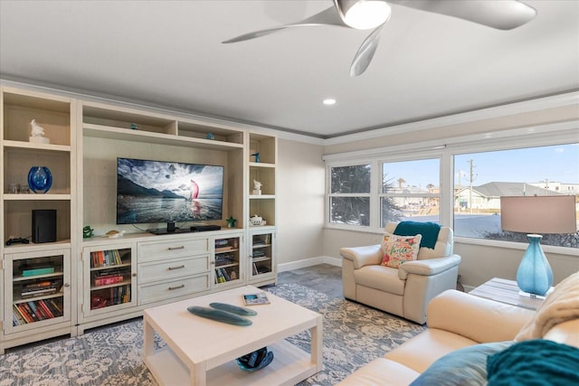 living room with crown molding and ceiling fan