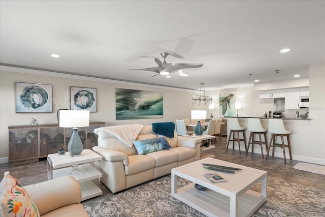 living room with an inviting chandelier and ornamental molding