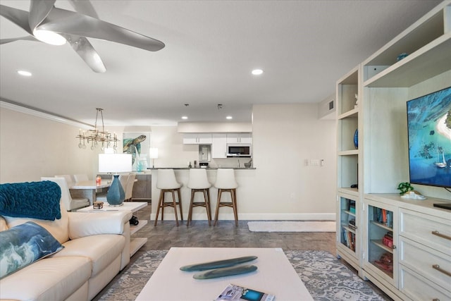 living room featuring ceiling fan with notable chandelier