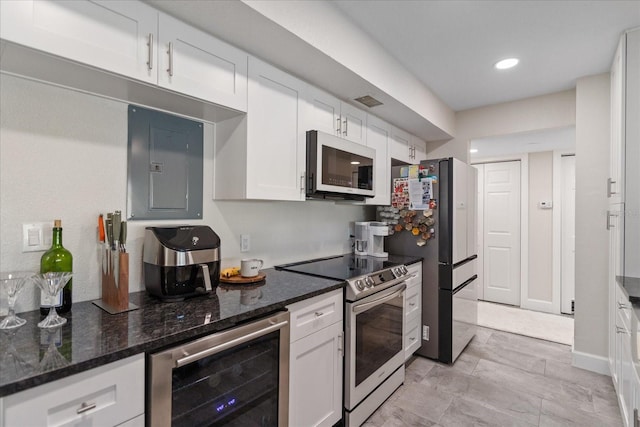 kitchen with electric panel, wine cooler, dark stone countertops, white cabinetry, and stainless steel appliances