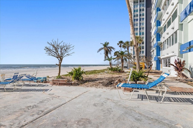 exterior space with a water view and a view of the beach