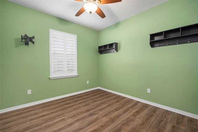 unfurnished room featuring dark wood-type flooring and ceiling fan