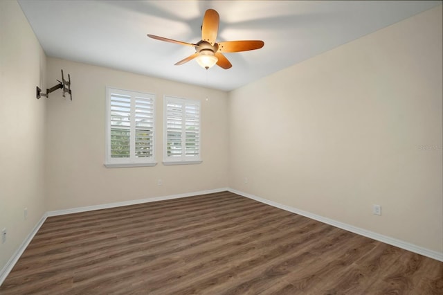 spare room with ceiling fan and dark hardwood / wood-style floors