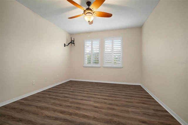 empty room with ceiling fan and dark hardwood / wood-style floors