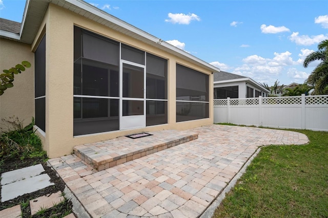 view of patio / terrace featuring a sunroom