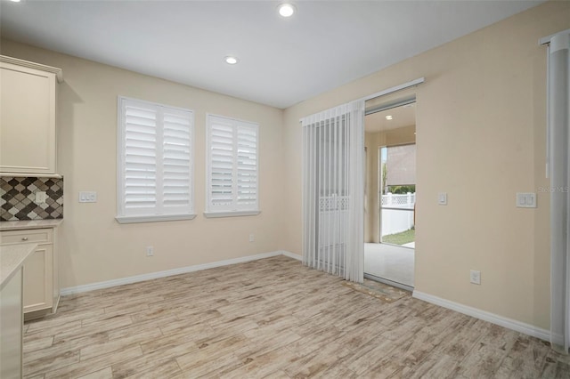 unfurnished dining area with light hardwood / wood-style flooring