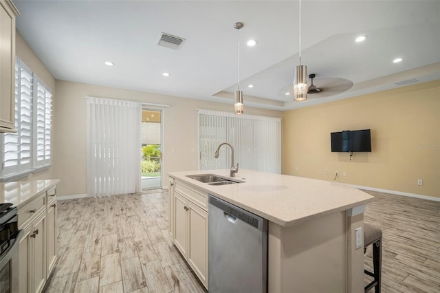 kitchen with ceiling fan, dishwasher, pendant lighting, a raised ceiling, and sink