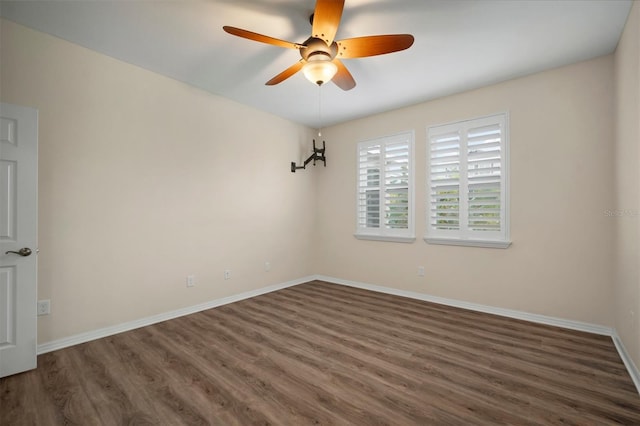 unfurnished room featuring ceiling fan and dark hardwood / wood-style flooring