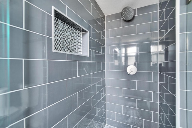 bathroom with tiled shower