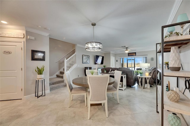 dining space featuring ceiling fan with notable chandelier and ornamental molding