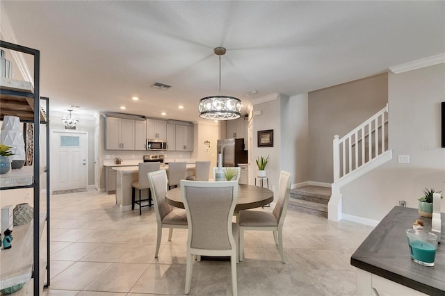 tiled dining area with an inviting chandelier and ornamental molding