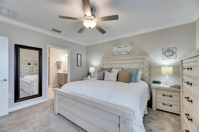 carpeted bedroom featuring ceiling fan, crown molding, and ensuite bathroom