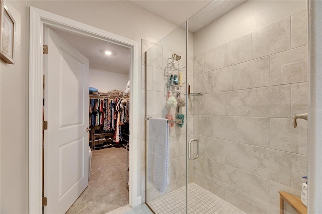 bathroom with a shower with door