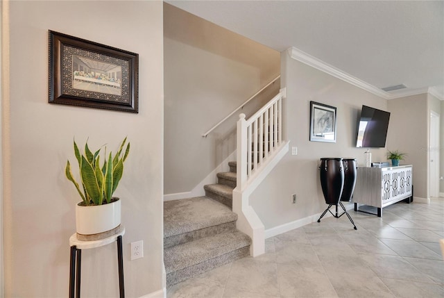 stairway with tile patterned flooring and crown molding