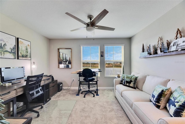 carpeted office with ceiling fan and a textured ceiling