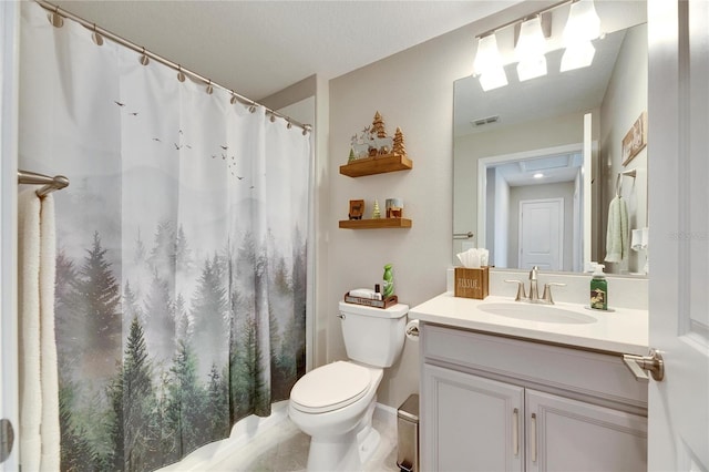 bathroom with toilet, vanity, and a shower with shower curtain