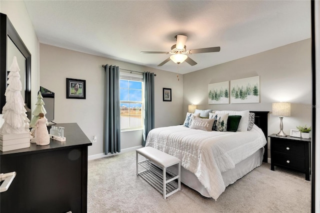 bedroom with ceiling fan and light colored carpet