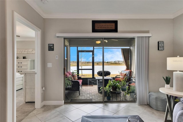 doorway featuring light tile patterned floors, crown molding, and a water view