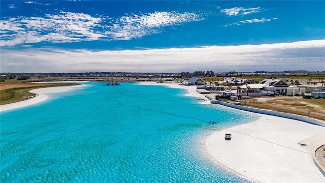 view of swimming pool featuring a beach view and a water view