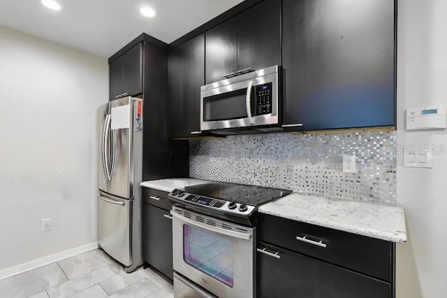 kitchen with light stone countertops, light tile patterned floors, stainless steel appliances, and tasteful backsplash