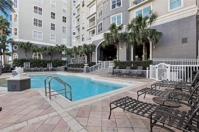 view of swimming pool featuring a patio area