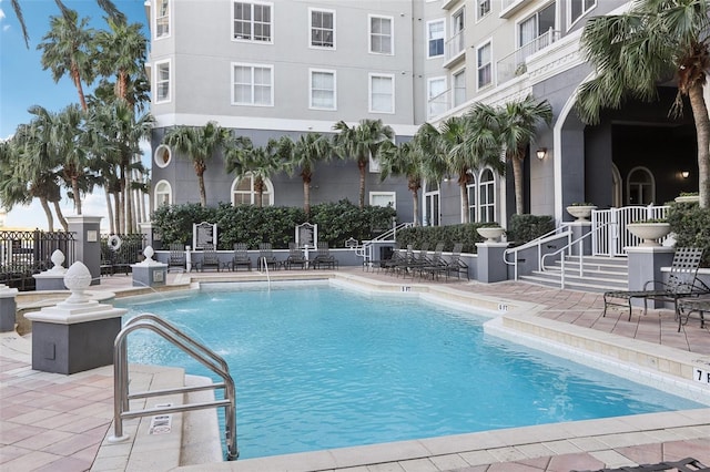 view of pool featuring pool water feature and a patio