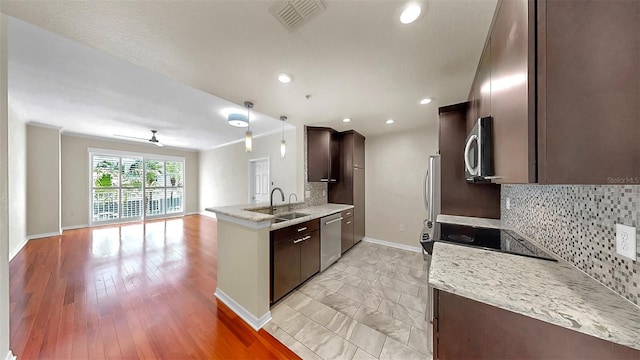 700 S Harbour Island Blvd Unit 226, Tampa, FL 33602 - kitchen with appliances with stainless steel finishes, dark brown cabinets, open floor plan, a peninsula, and decorative backsplash