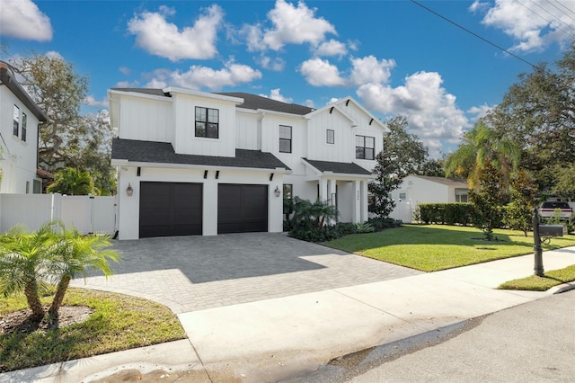 view of front of house featuring a front lawn and a garage